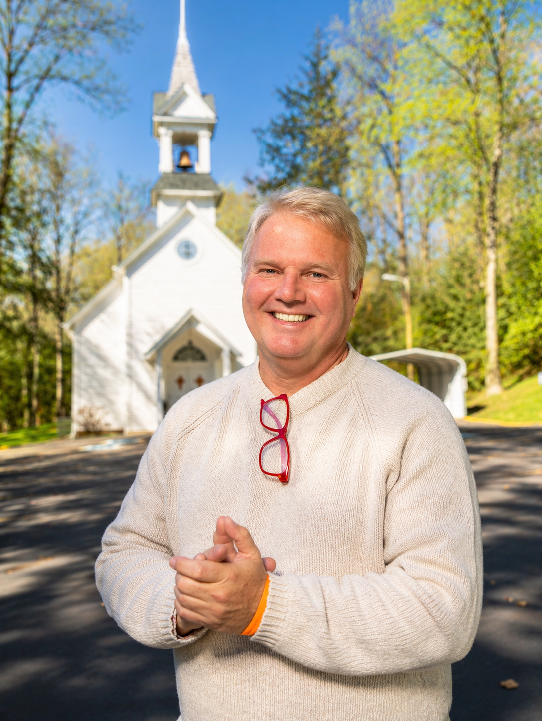 Senior man smiling outside church after getting life insurance coverage quickly online with TrustedLifeRates